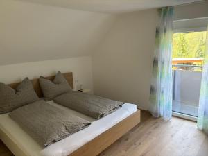 a bed in a room with a window and a bedvisor at Ferienhaus Meisterl in Sankt Marein bei Neumarkt