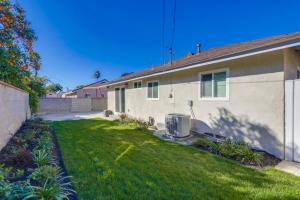 a house with a green lawn in front of it at Beautiful Remodel 3 Bedroom 2 bathroom Home with Pool & Jacuzzi in Fullerton