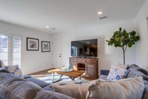 a living room with a couch and a table at Beautiful Remodel 3 Bedroom 2 bathroom Home with Pool & Jacuzzi in Fullerton