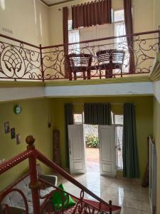 a balcony with chairs on the second floor of a house at Priv garut in Garut