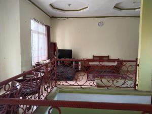 a room with a balcony with a table and chairs at Priv garut in Garut