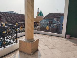 a balcony with a column on top of a building at Priv garut in Garut +14 photos