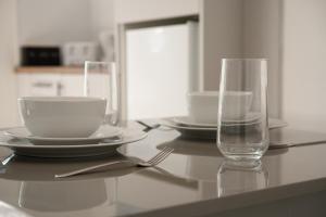a table with plates and a glass on it at Stockton Suites in Stockton-on-Tees +43 photos