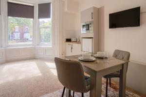 a dining room with a table and chairs at Stockton Suites in Stockton-on-Tees