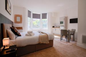 a bedroom with a bed with a teddy bear on it at Stockton Suites in Stockton-on-Tees