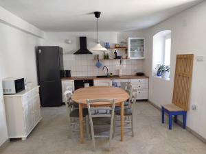 a kitchen with a table and chairs in a room at Loparina House in Nerezine