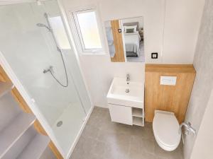 a bathroom with a toilet and a sink and a shower at Camping Derby Loredo by Mola! in Loredo +81 photos