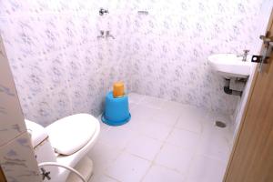 a bathroom with a toilet and a sink at WildCliff pool huts in Meppādi +32 photos