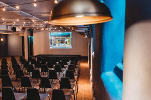 an empty room with chairs and a projection screen at Whitworth Locke in Manchester