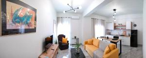a living room with a couch and a table at N&K Yellow Pearl Flat in Volos