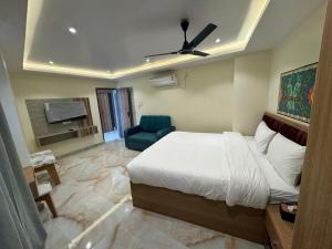 a bedroom with a bed and a blue chair at Hotel Skyline in Janakpur