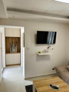a living room with a flat screen tv on the wall at Apartman Đurišić in Prijevor +4 photos