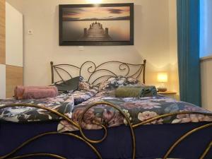 a bedroom with a bed with a picture on the wall at Residence Villa Fiore Portorož in Portorož