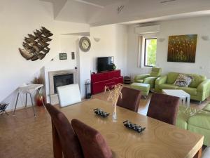 ein Wohnzimmer mit einem Tisch und einem Sofa in der Unterkunft Villa Dreams in Golf Club Ibar in Dolna Banya