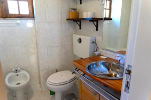 a small bathroom with a toilet and a sink at Casa das Marias by Gerês Casas in Geres +34 photos