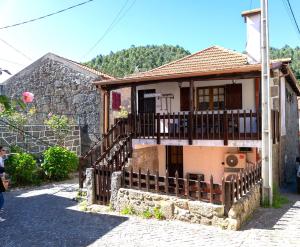 a small house with a staircase leading up to it at Casa das Marias by Gerês Casas in Geres