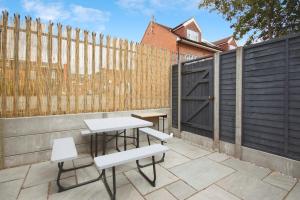 a patio with a table and two chairs and a fence at APod in Coventry +3 photos