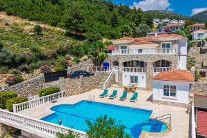 a villa with a swimming pool and a house at TEKCE Yeşilüzümlü Villa No 17 in Uzumlu