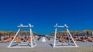 a group of chairs and umbrellas on a beach at Mera Resort in Venus