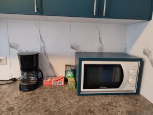 a microwave sitting on top of a kitchen counter at Apartament b&b Rădăuți in Rădăuţi +13 photos