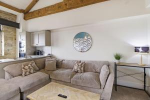 a living room with a couch and a table at Heritage Serviced Suites - Serviced Apartments in Huddersfield +35 photos
