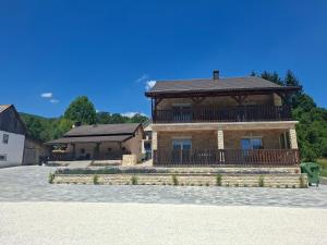 a house with a balcony on top of it at Jakiland house Plitvice Lakes in Korenica