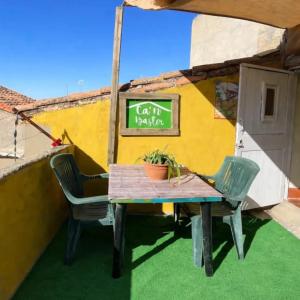 a table and chairs in front of a building at Ca'n Baster 1878 in Juncosa