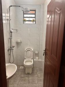 a bathroom with a toilet and a sink at Nalim bliss garden in Ruiru