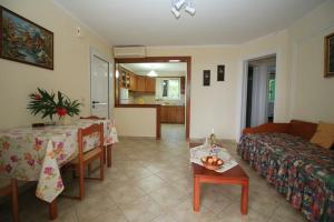 a living room with a couch and a table at Palman Othonoi House in Othonoi