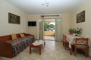 a living room with a couch and a table at Palman Othonoi House in Othonoi