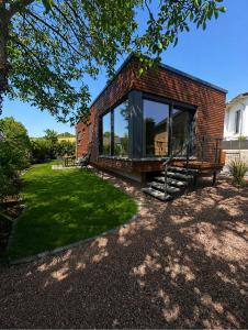 a brick house with a bench and a window at Erftlodges L1 in Bad Münstereifel