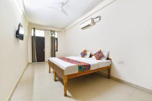 a bedroom with a bed in a room at FabHotel Palak Palace in Jaipur
