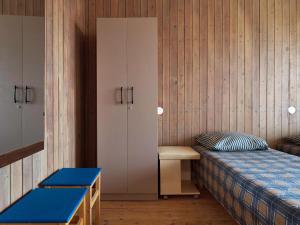 a bedroom with a bed and a cupboard and a bed and a cabinet at Private double room with balcony in Neringa