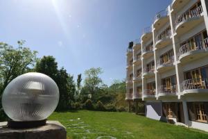 a building with a silver ball in front of it at Swaasha Vista in Kausani