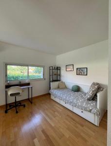 a bedroom with a bed and a desk in it at Maison d'architecte in Cébazat