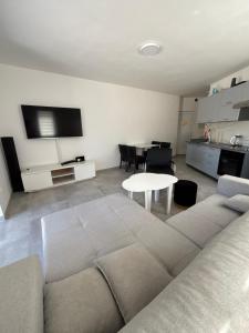 a living room with a couch and a table at Beachside Apartments Novalja in Stara Novalja