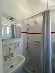 a bathroom with a sink and a shower with a mirror at Mpiritis Mare in Lefkandi Chalkidas +41 photos