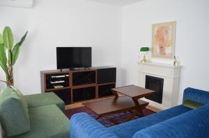 a living room with two blue couches and a tv at Apartman Vera in Prijedor