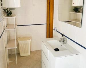 a white bathroom with a sink and a mirror at Villa SOFIA - Costa Blanca in Benissa +22 photos