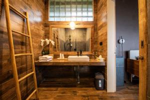 a bathroom with a sink and a mirror at Wanagiri Reserve in Gitgit +80 photos