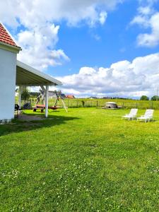 a group of chairs sitting in a grass field at #MazuryOFFline in Giżycko