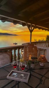 two glasses of red wine on a tray on a table at Villa Punta in Rovanjska +9 photos
