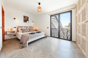 a bedroom with a bed and a balcony at Casa Gabriel in Estômbar +80 photos