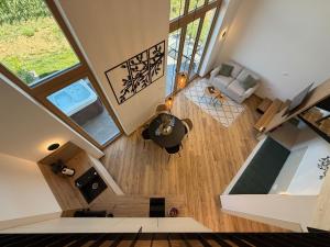 an overhead view of a living room with wood floors at Glamping resort Dolenjc in Novo Mesto
