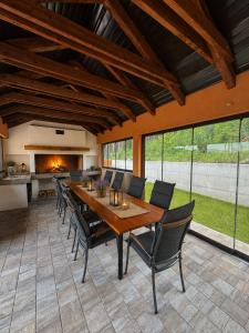 a dining room with a wooden table and chairs at Kuća za odmor Bruna in Livno
