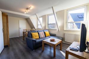 a living room with a couch and a table at Appartement Tümmelkoje in Sankt Peter-Ording