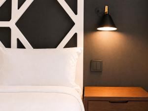 a bedroom with a bed and a lamp and a table at The Twenties by GuestReady in Lisbon