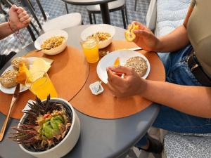 two people sitting at a table with food and drinks at The Twenties by GuestReady in Lisbon