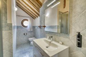a bathroom with a sink and a toilet at Podere Montale Winery in Seggiano +68 photos