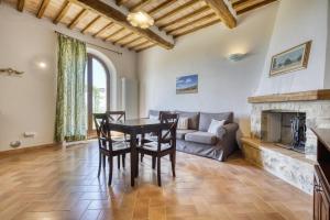 a living room with a table and chairs and a couch at Podere Montale Winery in Seggiano